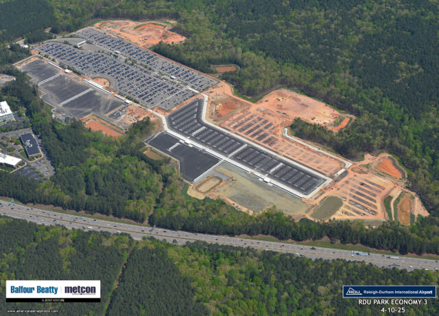 Aerial view of RDU Park Economy 3 under construction, surrounded by dense forest, with logos for Balfour Beatty and Metcon.