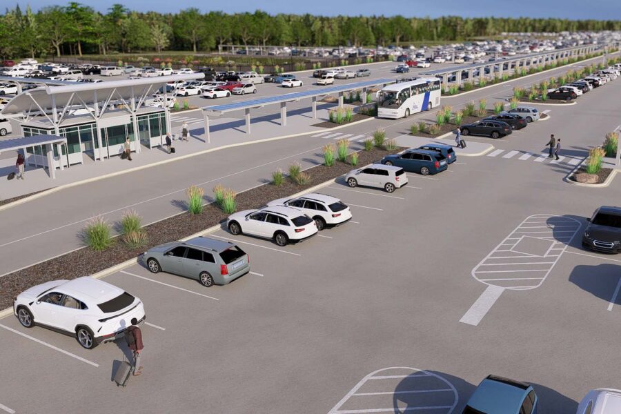 Parking lot with cars and people, bus station nearby, trees in background