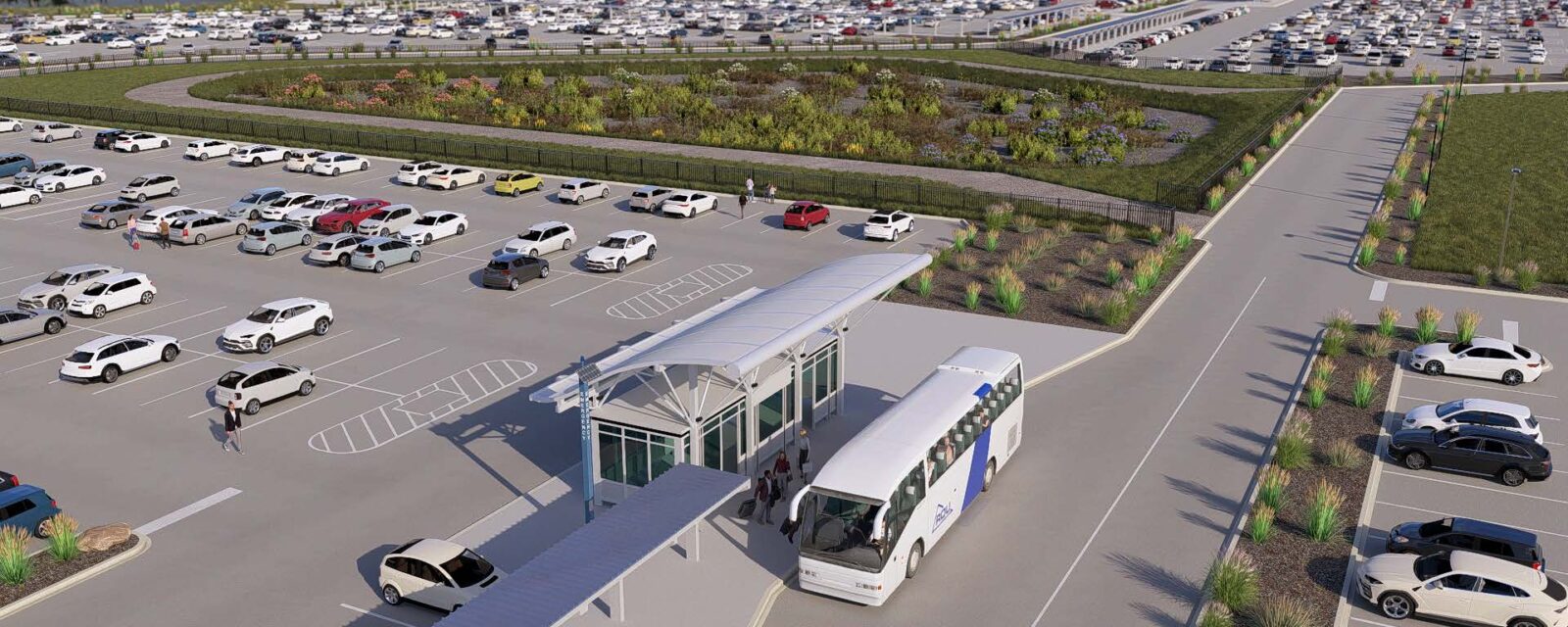 Bus terminal in large parking lot with landscaped areas and numerous parked cars.