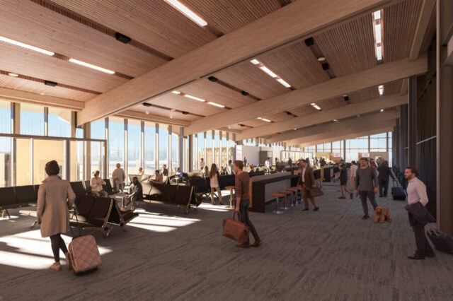 Spacious airport terminal with wood ceiling, large windows, and travelers waiting or walking.