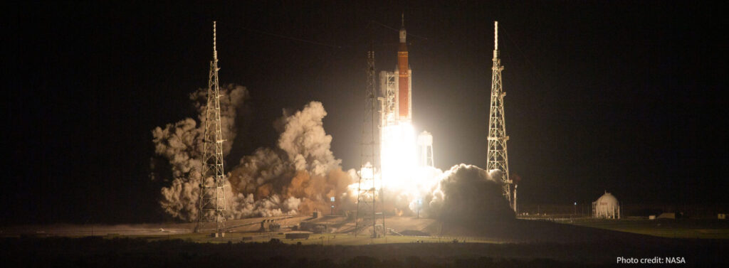 Rocket launch at night with bright flames and smoke. Photo credit: NASA